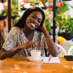 closeup-portrait-happy-young-black-woman-drinking-coffee-cafe_231208-11037